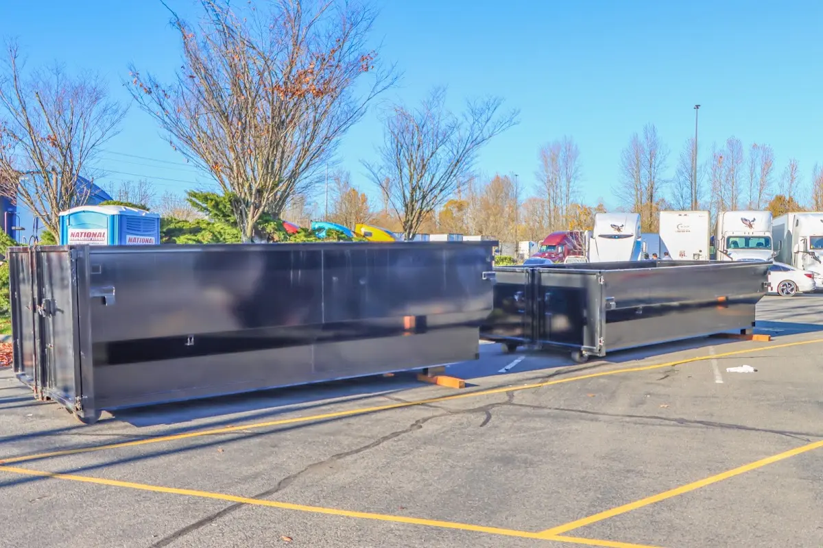 Professional dumpster rental service with roll-off container on residential driveway in Lake Arrowhead